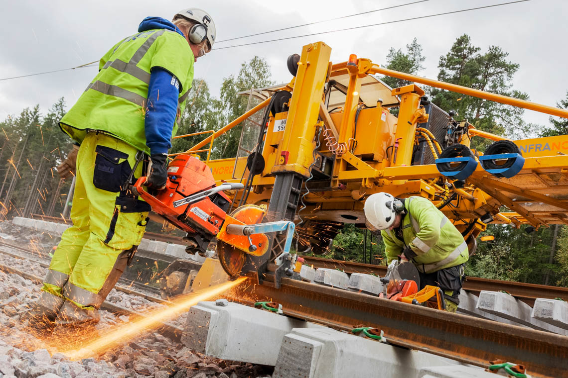 Två personer arbetar på spårområdet